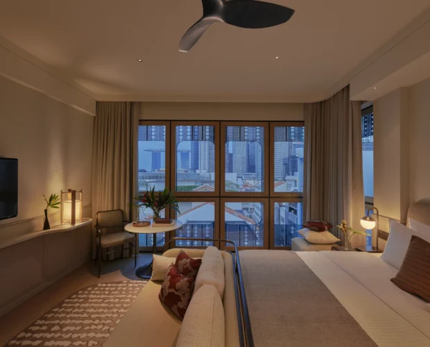 Urban Luxe room at 21 Carpenter Hotel in Singapore with drawn curtains, a double bed and soft warm lighting